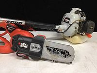 Echo GT-400R gas trimmer and Black & Decker chain saw clippers side by side showing full length and branding