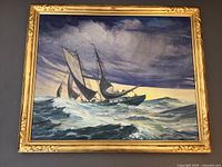 Full view of framed painting showing gold-painted wood frame and seascape composition