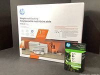 Front and side view of HP DeskJet 4155e printer box showing printer image and key features in English and French.