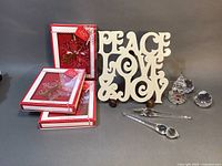 Group photo showing the ceramic trivet, three boxed 2019 Lenox ornaments, crystal prisms, and snowman figurine arranged on table.