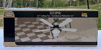 Photo of the unopened box showing the Canarm Eclipse 42 inch ceiling fan with image of the fan and product branding.