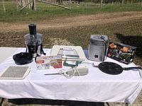 Wide shot of all seven kitchen tools on white cloth