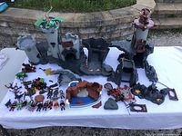 Full display of the Playmobil Great Dragon Castle pieces and figures showing castle, dragon, figures, and accessories scattered on a white cloth.