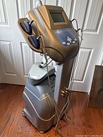 Full view of device showing console, LCD screen, base, and handpiece holders