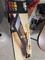 Boxed Salton electric hotray showing product image and branding from top perspective on a table.