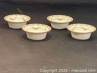Photo showing all four Minton cream soup bowls together from side angle revealing rim decoration and shape