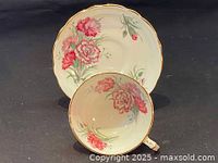 Overhead view showing floral patterns inside teacup and on saucer.