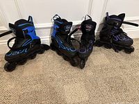 Three pairs of adjustable inline skates in blue, red, and purple flame designs, showing overall condition and wheel configuration.