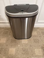 Front view of the NINESTARS stainless steel touchless trash can with closed lid.