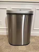 Front view of the stainless steel semi-round trash can showing the smooth brushed finish.