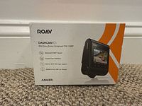 Front of ROAV DashCam C1 box showing product image and features like Sony Exmor sensor, Full HD 1080P, WiFi and app support, Anker USB car charger included.