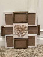 Front view of wooden collage photo frame with brown and white frames and string heart centerpiece.