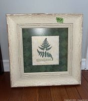 Framed Leather Fern botanical print approximately 9x9 inches, distressed white wooden frame.