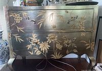 Front view of metallic floral dresser