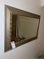 Full view of the rectangular 36x24 gold framed mirror mounted on a wall showing the entire item and its bevelled edges.
