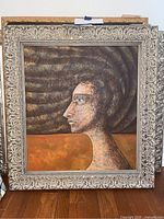 Full view of original oil painting portrait in ornate frame, showing profile of a woman with textured hair.