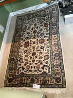 Full view of wool area rug showing pattern and borders