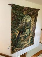 Full view of tapestry hung on wall with rod