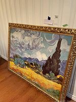 Oblique front view of framed print leaning against wall