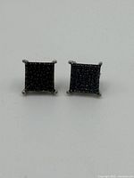 Front view of the square black diamond stud earrings showing the grid-like pattern of small black diamonds.