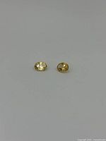 Two oval citrine gemstones on a white background showing shape and color.