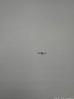 Three small round diamond gemstones placed on a flat surface for display.