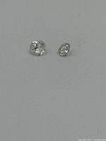 Two loose diamonds on white background showing shape and size