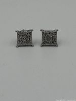 Front-facing view of both diamond stud earrings showing the square cluster of small diamonds on each earring.