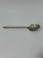 Sterling silver teaspoon with bamboo style textured handle and oval bowl, some tarnishing and use marks.