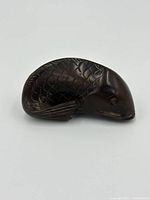 Side angle showing detailed scale carvings and the shape of the carp figurine.