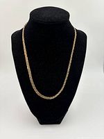 Front view of the silver braided chain on a black display bust showing length and shine.