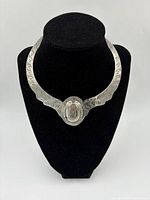 Front view of sterling silver Aztec collar necklace on display bust showing engraved details and centerpiece.