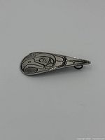 Front view of the sterling silver eagle pendant highlighting engraved Native American inspired design.