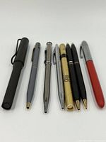 Eight vintage pens arranged side by side on a white background, showing variety in color and style