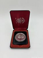 Front of the open case with the coin showing the Winnipeg 100 years commemorative design