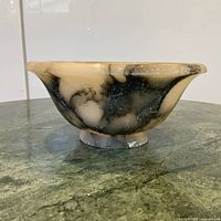 Side profile showing exterior veining and footed base