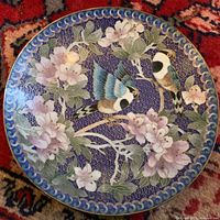 Front of cobalt blue cloisonné plate with birds and blossoms decoration