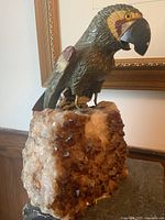 Full view of carved parrot on amethyst base