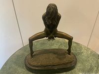 Full view of bronze nude female sculpture on granite base