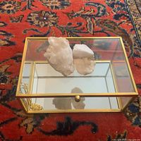 Overview of glass box with brass trim and quartz crystals inside