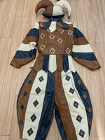 Full view of coat with hood and pants laid flat