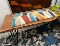 Runner displayed on wooden surface, full length view