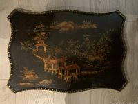 Full view of scalloped-edge tray showing brass gallery and painted chinoiserie scene