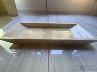 Side view of entire beige marble tray