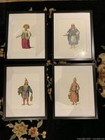All four framed costume prints laid out