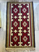 Full view of carpet showing pattern and fringe