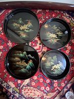 All four trays laid out to show painted designs and relative sizes