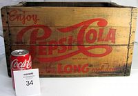 Front and side view of the Pepsi Cola wooden crate showing embossed logo and original paint.