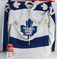 Front view of white and navy Toronto Maple Leafs vintage youth hockey jersey with lace-up collar, maple leaf logos on shoulders, large maple leaf crest with team name on chest, and sleeve number 27.