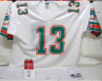 Front view of the white Miami Dolphins football jersey with number 13 and Champion logo visible on sleeve and tag.